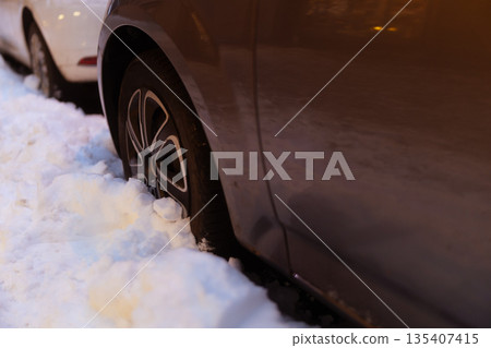 Car Tire Stuck in Deep Winter Snow Car Tire Stuck in Deep Winter Snow 135407415