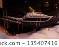 Front Bumper of a Car Covered in Ice and Icicles 135407416