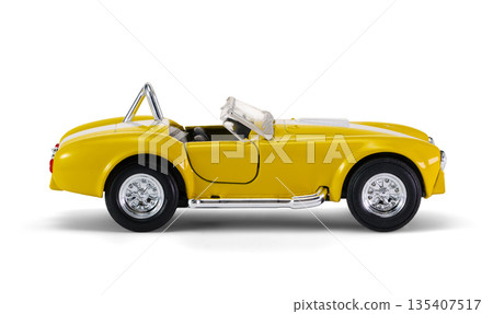 Miniature yellow toy racing car on white background 135407517