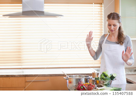 White home cook lifting and preparing vegetables in colander by pot in kitchen, copy space White home cook lifting and preparing vegetables in colander by pot in kitchen, copy space 135407588