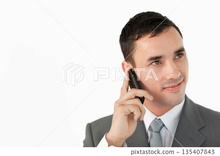 Man in grey suit and tie talking on smartphone in studio with white backdrop, copy space 135407843
