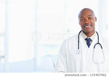 African American male doctor standing in hospital hallway with stethoscope and lab coat, copy space 135407902