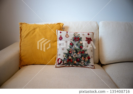 Cozy living room still life with decorative Christmas pillow and warm yellow cushion on sofa Cozy living room still life with decorative Christmas pillow and warm yellow cushion on sofa 135408716