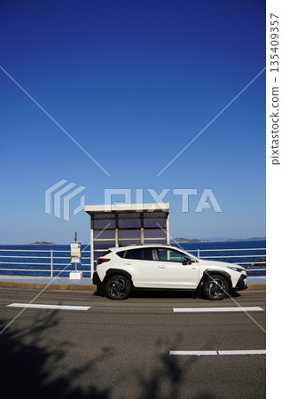 A white car parked along the coast A white car parked along the coast 135409357