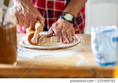 Detail of hands of men rolling the dough. Preparation for baking of traditional czech pastry. Homemade fresh food Detail of hands of men rolling the dough. Preparation for baking of traditional czech pastry. Homemade fresh food 135409785