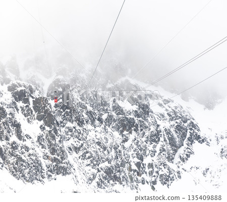 Cable car to Lomnicky stit peak, High Tatras region, Slovakia. Winter and cloud weather. Cable car to Lomnicky stit peak, High Tatras region, Slovakia. Winter and cloud weather. 135409888