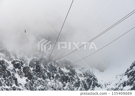Cable car to Lomnicky stit peak, High Tatras region, Slovakia. Winter and cloud weather. 135409889