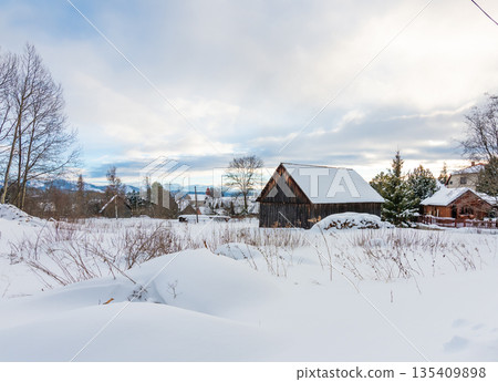 Small houses covered with snow in winter at Slovakia High Tatras mountains. Winter weather. 135409898