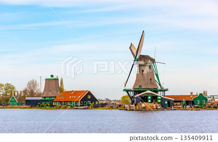 Traditional windmills over at the Zaanse Schans, cloudy weather Traditional windmills over at the Zaanse Schans, cloudy weather 135409911