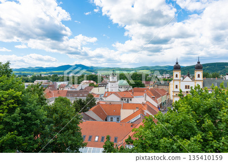 View of city Trencin, Slovakia. Beautiful town square with panoramic view to ancient Castle on the hill. Summer day with blue sky. View of city Trencin, Slovakia. Beautiful town square with panoramic view to ancient Castle on the hill. Summer day with blue sky. 135410159