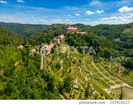 Aerial drone fly near the Pernstejn castle, Czech Republic. Vysocina region near the Nedvedice village. Summer day with sun and blue sky. Green nature and fresh forest. Aerial drone fly near the Pernstejn castle, Czech Republic. Vysocina region near the Nedvedice village. Summer day with sun and blue sky. Green nature and fresh forest. 135410227