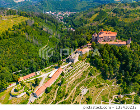 Aerial drone fly near the Pernstejn castle, Czech Republic. Vysocina region near the Nedvedice village. Summer day with sun and blue sky. Green nature and fresh forest. 135410232
