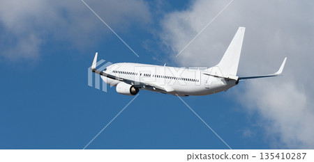 Airplane take off on the blue sky, with white clouds. Aircraft flying on sky background. White passenger jet plane in the blue sky. Low angle view of Airplane flying under blue sky, with white clouds Airplane take off on the blue sky, with white clouds. Aircraft flying on sky background. White passenger jet plane in the blue sky. Low angle view of Airplane flying under blue sky, with white clouds 135410287
