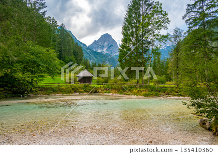 The Krumme Steyr river near the village Hinterstoder and famous lake Schiederweiher. Pure fresh water near Austrian Alps and mountains peaks. Soft colors, peace in nature. 135410360