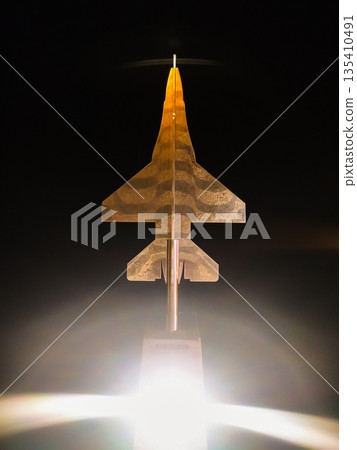 A sleek, glowing fighter jet model symbolizes futuristic aerospace technology and stealth. Perfect for projects focused on aviation innovation, national defense, and hightech engineering. 135410491