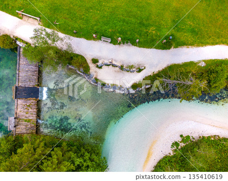 Schiederweiher in Hinterstoder top bottom drone aerial view to small dam and flowing water Schiederweiher in Hinterstoder top bottom drone aerial view to small dam and flowing water 135410619