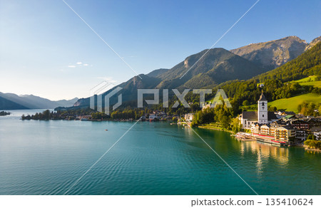 Beautiful aerial view of the popular village of Sankt Wolfgang im Salzkammergut. Alpine mountains, church and Wolfgangsee. Upper Austria, Salzburg. Beautiful aerial view of the popular village of Sankt Wolfgang im Salzkammergut. Alpine mountains, church and Wolfgangsee. Upper Austria, Salzburg. 135410624