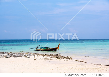 Long tailed boats near tropical beach at Ko Phi Phi, Thailand. Tropic beach with white sand and turquoise water, concept of vacation in paradise. 135410739