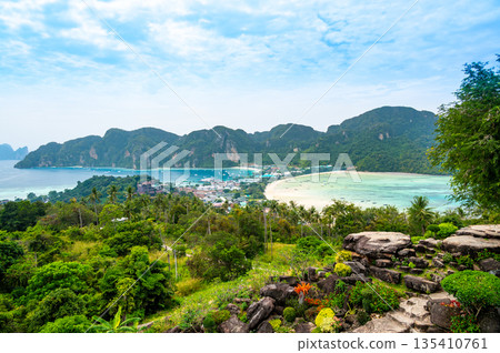Aerial view of Ko Phi Phi islands, Thailand. Lookout from the viewpoint to tropical island, beach and ocean with long tail boats. Exotic nature, summer weather. Aerial view of Ko Phi Phi islands, Thailand. Lookout from the viewpoint to tropical island, beach and ocean with long tail boats. Exotic nature, summer weather. 135410761