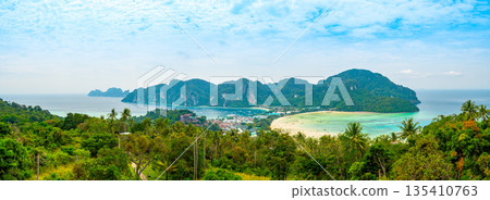 Aerial view of Ko Phi Phi islands, Thailand. Lookout from the viewpoint to tropical island, beach and ocean with long tail boats. Exotic nature, summer weather. 135410763