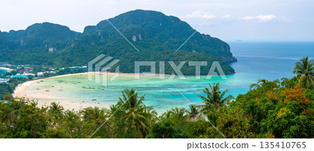 Aerial view of Ko Phi Phi islands, Thailand. Lookout from the viewpoint to tropical island, beach and ocean with long tail boats. Exotic nature, summer weather. Aerial view of Ko Phi Phi islands, Thailand. Lookout from the viewpoint to tropical island, beach and ocean with long tail boats. Exotic nature, summer weather. 135410765