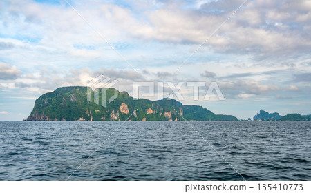 View of limestone rock at Ko Phi Phi islands, Thailand. View from long tailed boat. Exotic and tropic nature, summer paradise. View of limestone rock at Ko Phi Phi islands, Thailand. View from long tailed boat. Exotic and tropic nature, summer paradise. 135410773