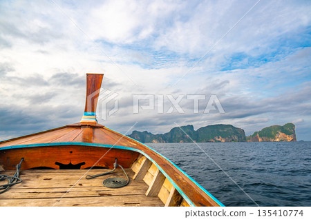 View of limestone rock at Ko Phi Phi islands, Thailand. View from long tailed boat. Exotic and tropic nature, summer paradise. View of limestone rock at Ko Phi Phi islands, Thailand. View from long tailed boat. Exotic and tropic nature, summer paradise. 135410774