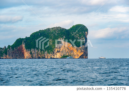 View of limestone rock at Ko Phi Phi islands, Thailand. View from long tailed boat. Exotic and tropic nature, summer paradise. View of limestone rock at Ko Phi Phi islands, Thailand. View from long tailed boat. Exotic and tropic nature, summer paradise. 135410776
