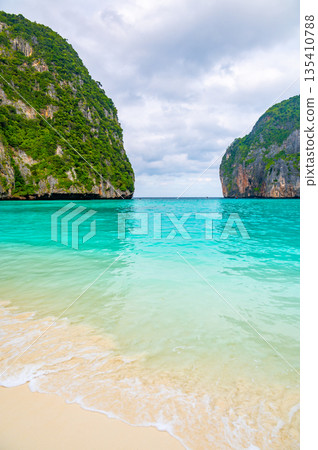 View of famous Maya Bay, Thailand. One of the most popular beach in the world. Ko Phi Phi islands. Beach without people. View of famous Maya Bay, Thailand. One of the most popular beach in the world. Ko Phi Phi islands. Beach without people. 135410788