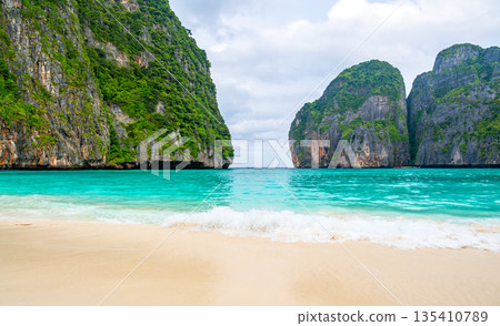 View of famous Maya Bay, Thailand. One of the most popular beach in the world. Ko Phi Phi islands. Beach without people. View of famous Maya Bay, Thailand. One of the most popular beach in the world. Ko Phi Phi islands. Beach without people. 135410789