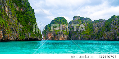 View of famous Maya Bay, Thailand. One of the most popular beach in the world. Ko Phi Phi islands. Beach without people. View of famous Maya Bay, Thailand. One of the most popular beach in the world. Ko Phi Phi islands. Beach without people. 135410791