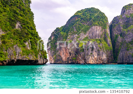 View of famous Maya Bay, Thailand. One of the most popular beach in the world. Ko Phi Phi islands. Beach without people. View of famous Maya Bay, Thailand. One of the most popular beach in the world. Ko Phi Phi islands. Beach without people. 135410792