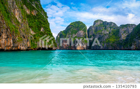 View of famous Maya Bay, Thailand. One of the most popular beach in the world. Ko Phi Phi islands. Beach without people. View of famous Maya Bay, Thailand. One of the most popular beach in the world. Ko Phi Phi islands. Beach without people. 135410793