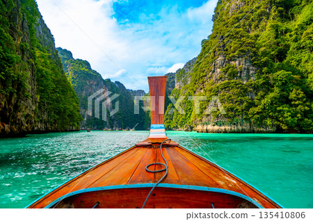 View of Pi Leh lagoon (also known as Green Lagoon) at Ko Phi Phi islands, Thailand. View from typical long tailed boat. Typical Thai picture of tropical paradise. Limestone rock and turquoise water. 135410806