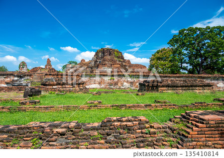 Ruins of ancient city and temples Ayutthaya, Thailand. Old kingdom of Siam. Summer day with blue sky. Famous tourist destination, spiritual place near Bangkok. Ruins of ancient city and temples Ayutthaya, Thailand. Old kingdom of Siam. Summer day with blue sky. Famous tourist destination, spiritual place near Bangkok. 135410814