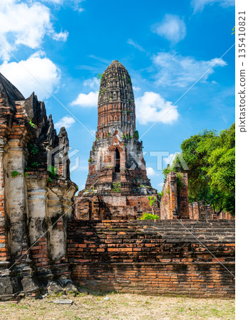 Ruins of ancient city and temples Ayutthaya, Thailand. Old kingdom of Siam. Summer day with blue sky. Famous tourist destination, spiritual place near Bangkok. Ruins of ancient city and temples Ayutthaya, Thailand. Old kingdom of Siam. Summer day with blue sky. Famous tourist destination, spiritual place near Bangkok. 135410821