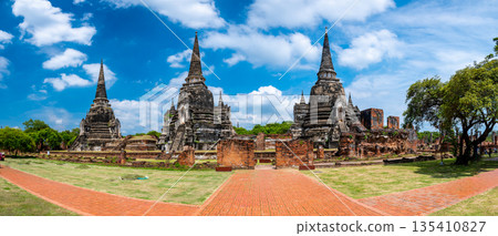 Ruins of ancient city and temples Ayutthaya, Thailand. Old kingdom of Siam. Summer day with blue sky. Famous tourist destination, spiritual place near Bangkok. 135410827
