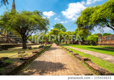 Ruins of ancient city and temples Ayutthaya, Thailand. Old kingdom of Siam. Summer day with blue sky. Famous tourist destination, spiritual place near Bangkok. 135410833