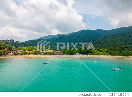 Aerial drone view of bamboo bay and beach at Koh Lanta island, Thailand. Tropical forest near the rocky beach and white sand with turquoise water. Aerial drone view of bamboo bay and beach at Koh Lanta island, Thailand. Tropical forest near the rocky beach and white sand with turquoise water. 135410934