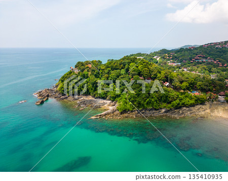 Aerial drone view of bamboo bay and beach at Koh Lanta island, Thailand. Tropical forest near the rocky beach and white sand with turquoise water. 135410935