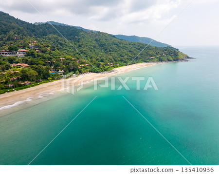 Aerial drone view of bamboo bay and beach at Koh Lanta island, Thailand. Tropical forest near the rocky beach and white sand with turquoise water. 135410936