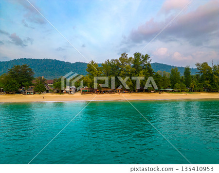 Aerial drone view of tropical beach at Ko Lanta island, Thailand. Coastline view of famous target destination. Pure turquoise water and white sand. Aerial drone view of tropical beach at Ko Lanta island, Thailand. Coastline view of famous target destination. Pure turquoise water and white sand. 135410953