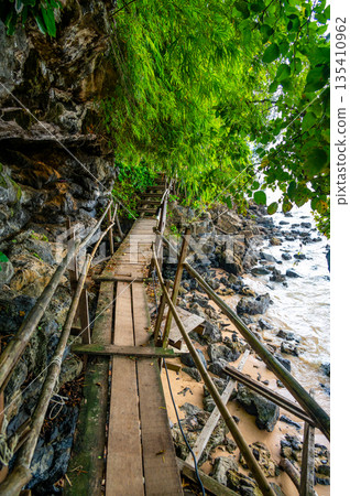 The Monkey trail starting at Ao Nang beach, Krabi province, Thailand. Wooden path in jungle. The Monkey trail starting at Ao Nang beach, Krabi province, Thailand. Wooden path in jungle. 135410962