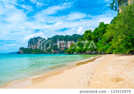 Long tail boats at Railay beach, Krabi, Thailand. Tropical paradise, turquoise water and white sand. Long tail boats at Railay beach, Krabi, Thailand. Tropical paradise, turquoise water and white sand. 135410979