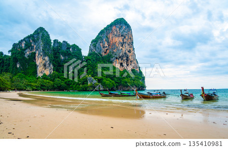 Long tail boats at Railay beach, Krabi, Thailand. Tropical paradise, turquoise water and white sand. 135410981