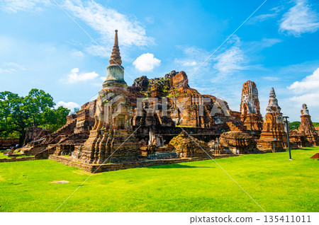 Ruins of ancient city and temples Ayutthaya, Thailand. Old kingdom of Siam. Summer day with blue sky. Famous tourist destination, spiritual place near Bangkok. Ruins of ancient city and temples Ayutthaya, Thailand. Old kingdom of Siam. Summer day with blue sky. Famous tourist destination, spiritual place near Bangkok. 135411011