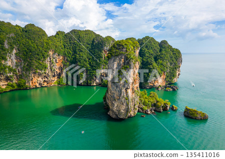 Ao Nang Tower, famous limestone rock near the Krabi town, Thailand. Aerial drone view to big rocks above turquoise sea. Exotic tourist destination. Ao Nang Tower, famous limestone rock near the Krabi town, Thailand. Aerial drone view to big rocks above turquoise sea. Exotic tourist destination. 135411016