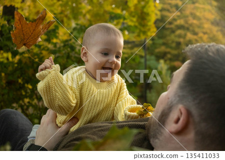 Father and Baby Enjoying Autumn Leaves 135411033