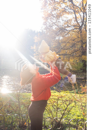 Father and Baby Enjoying Autumn in the Park Father and Baby Enjoying Autumn in the Park 135411049