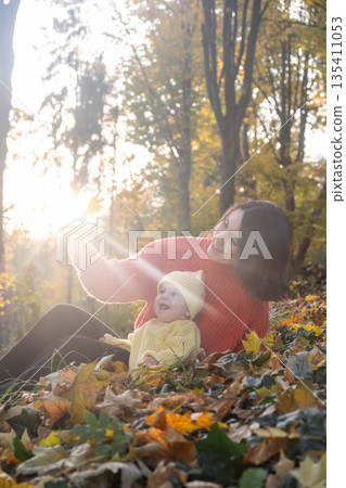 Mother and Baby Enjoying Autumn in Sunlit Forest Mother and Baby Enjoying Autumn in Sunlit Forest 135411053